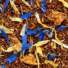 Close-up of Golden Sunset loose rooibos tea with blue cornflower and marigold petals